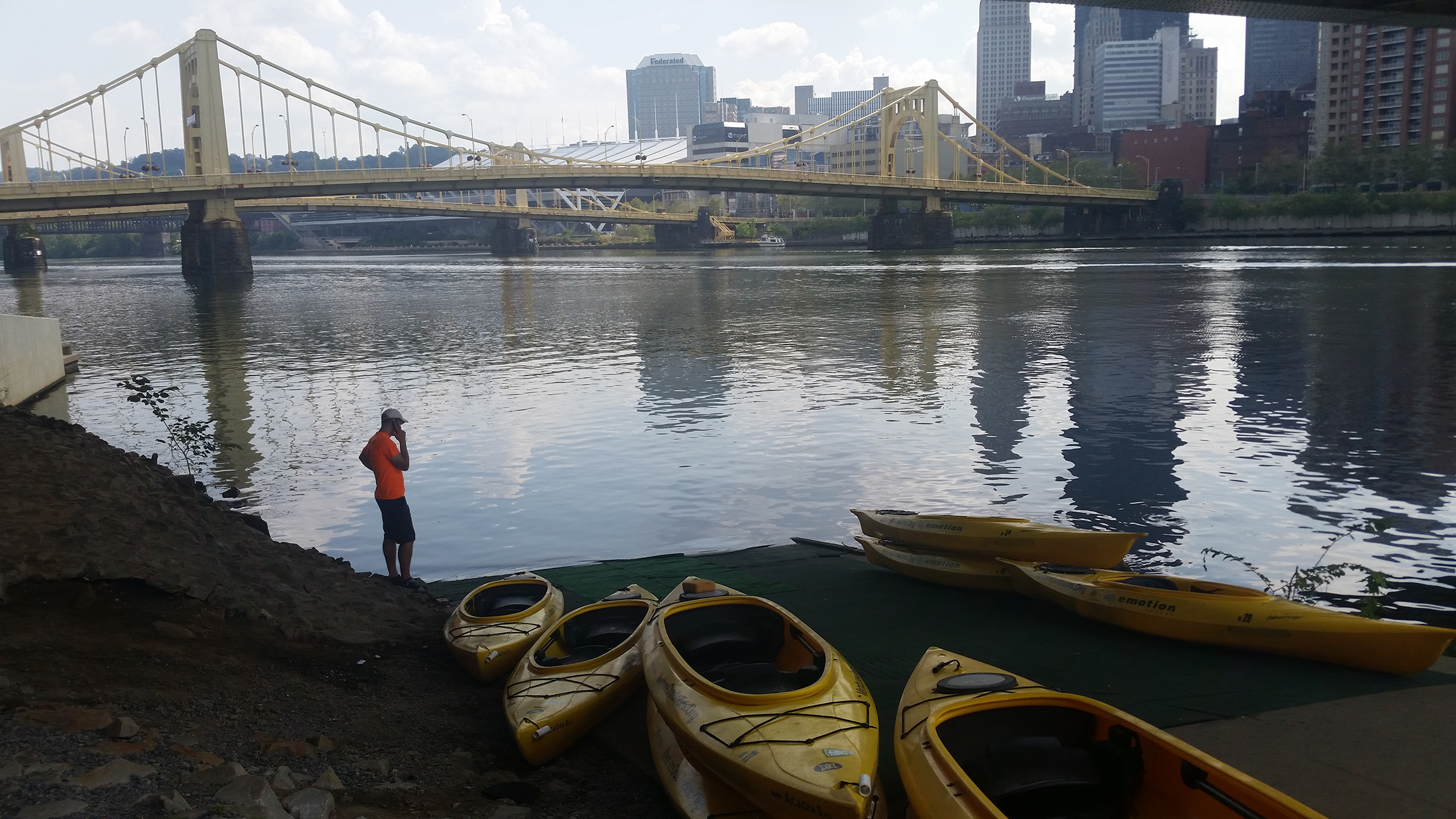 Alex Keim sets up our kayaks at Kayak Pittsburgh - North Shore. Check out that beautiful skyline in the distance.
