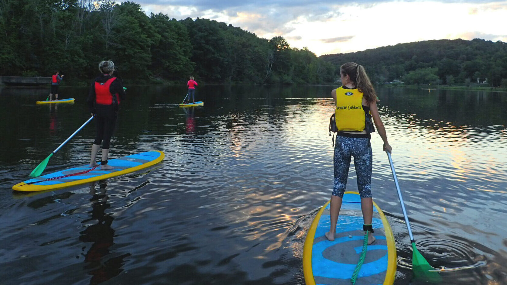 Participants stand up paddle boarding at North Park Lake