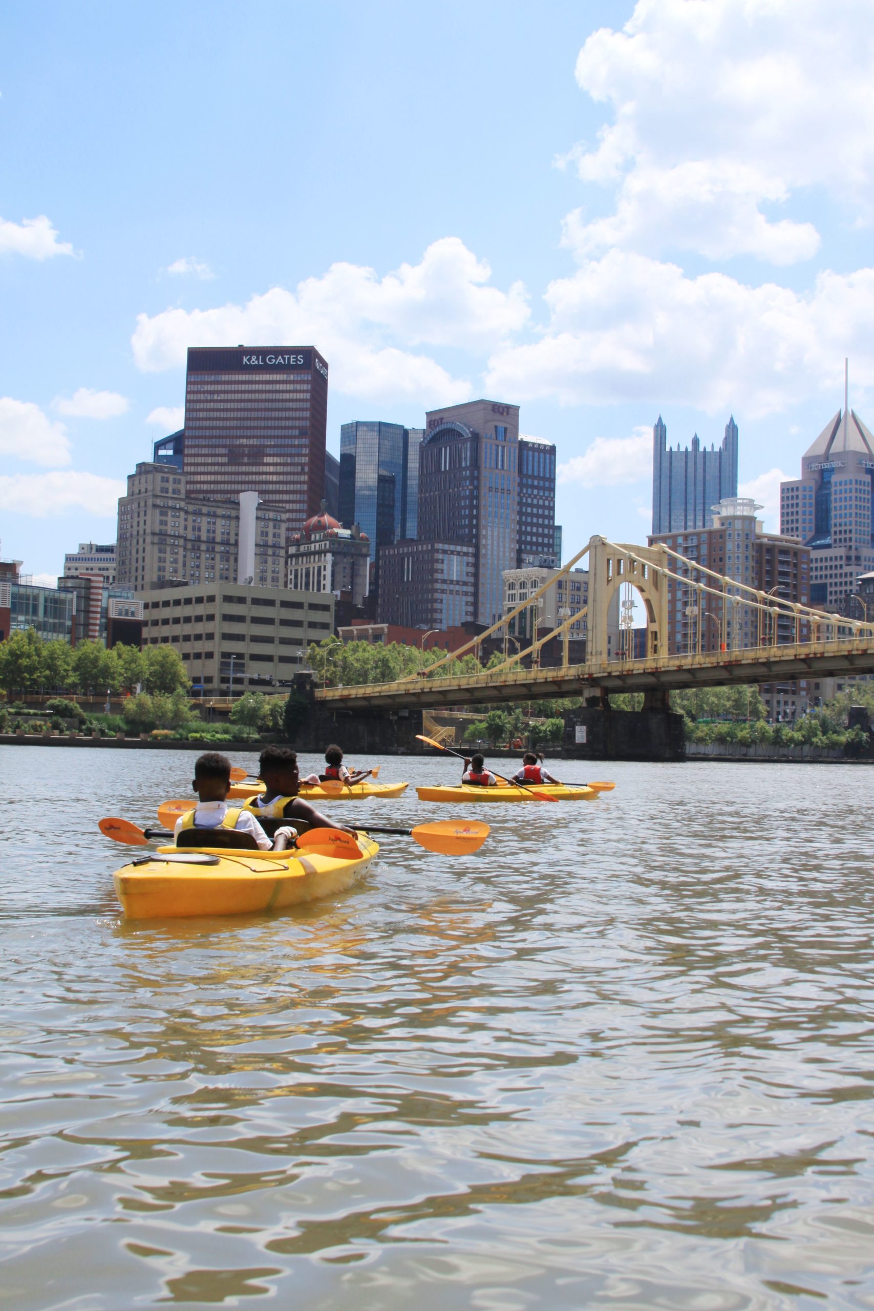 Participants enjoy the view of the Pittsburgh skyline from a kayak.